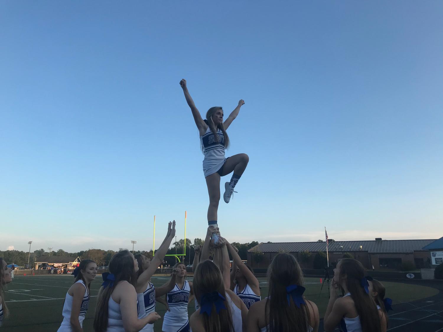 South Forsyth's cheer squad hoists their flyer up in the air to ramp up the crowd before the game. The cheerleaders continued to support the War Eagles with spirit and optimism throughout the rest of the game.
