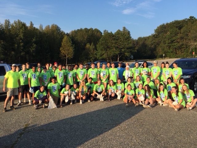 The volunteers gather early in the morning to clean up the shores of Lake Lanier. They were given bright, green shirts, trash bags, and gloves before going to pick up the trash.