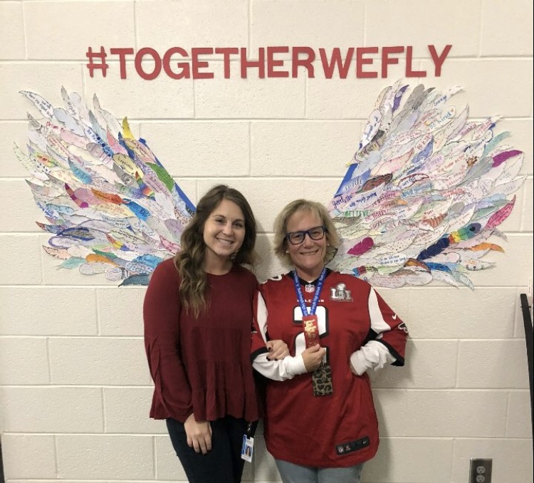 Mrs. Burnell and Ms. Frankel stand in front of wings constructed in the counselor's office from the feathers students made for Red Ribbon Week . The two counselors worked together on the events that occurred October 23 through the 30th.  