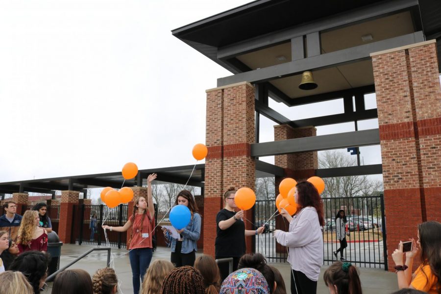 17 orange balloons were released one at a time in memory of the students and teachers.