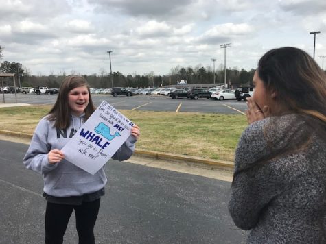 Lucy Taylor, left, asks Anvitha Bommineni, right, to Prom through a promposal saying Of all the fish in the sea, Im so glad you swam with me. Whale you go to prom with me?