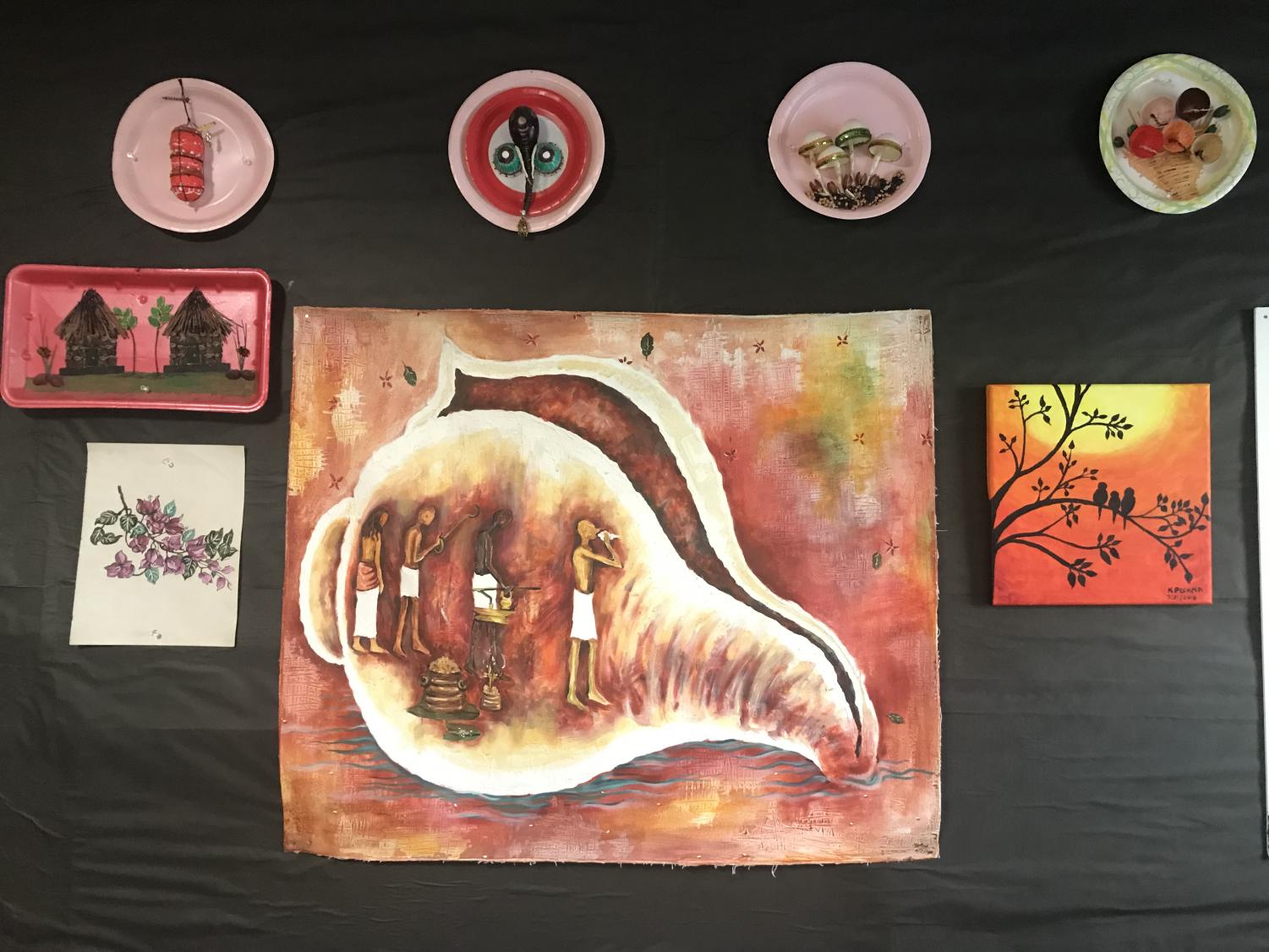 The detailed painting above (center canvas) can be described as nothing but a masterpiece. With meticulous detail work, Mrs. Sunil puts hours of time into perfecting her paintings, and making sure each piece expresses strong emotions or themes.