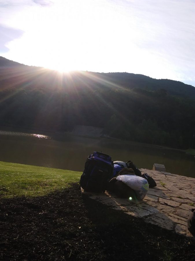 Sunrise in the valley. Outside of the Admin building, a campers bag waits to be picked up and taken home after a week of adventure.