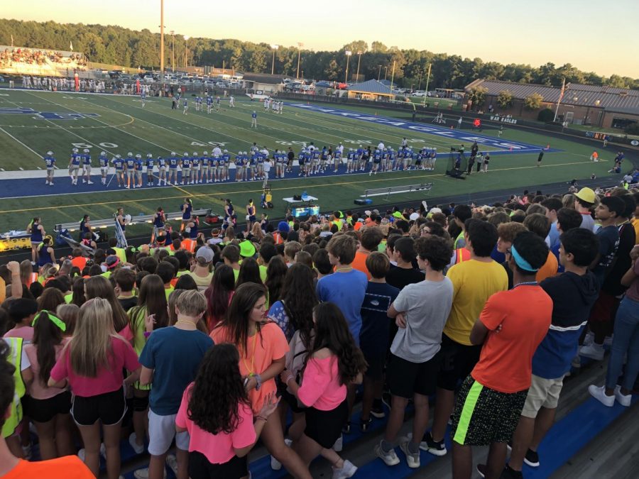 Shining Bright. After a day in neon, South students fill the stands with their brightly colored outfits to cheer on their favorite team.