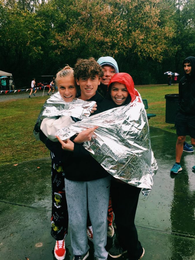 Bundle up. Mark Martin, Ansley Rogers, Emily Barnes, and Ashley Hunt cuddle up in the pouring rain. October 19th on a Saturday, runners from  South take on the speediest course and dominate it. The day being a mixture of rainy, and windy didnt stop them from running their hearts out on this meet. 