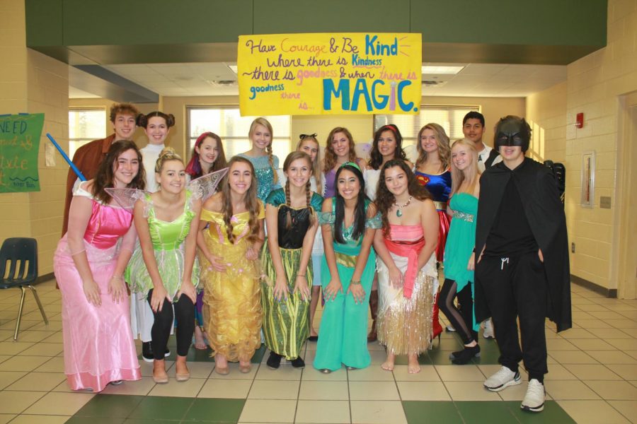 Captivating Crew. DECA members arrive early to A Magical Morning to prepare for the upcoming families. Julia Bradley and Sarah MacAllaster planned for months as volunteers gathered supplies, bought costumes, and created decorations.