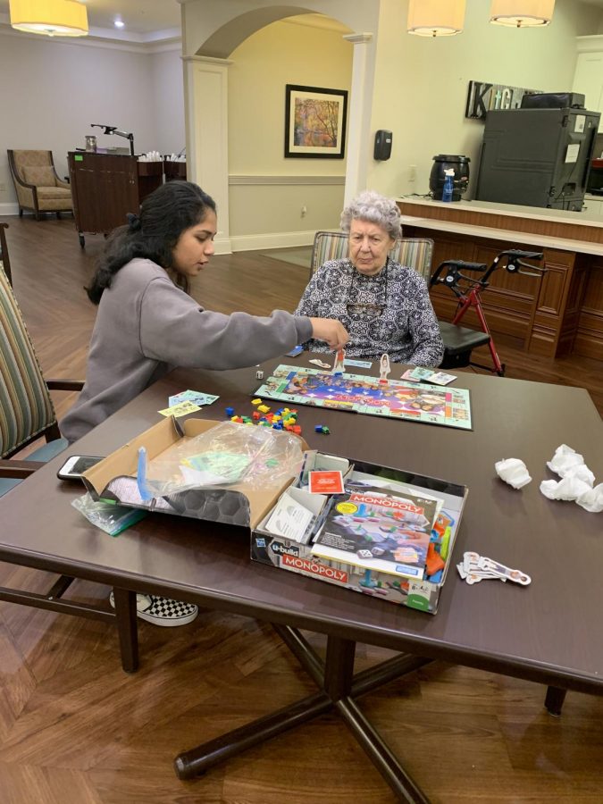 Mitali Bidkar sits will an elderly woman from Arbor Terrace. The day started with games like Headbandz and ended with a monopoly tournament to reinforce the American Enterprise System. This is one piece to a large puzzle. The three girls involved have worked hard to integrate business into the world through adults and children. 