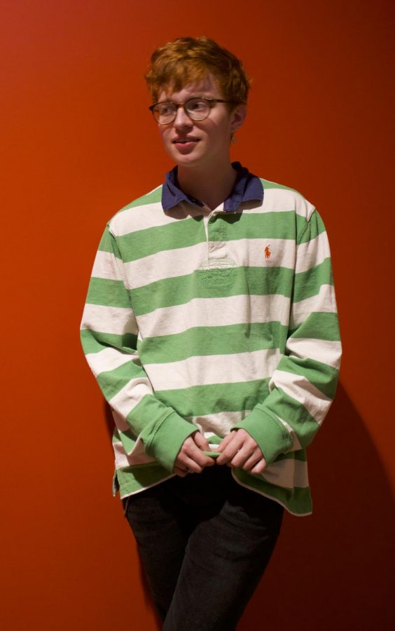 Artist photo. Robin Skinner poses in a green-stripped polo. Cavetown, Skinner's artist name, has gained over 250 million Spotify plays.