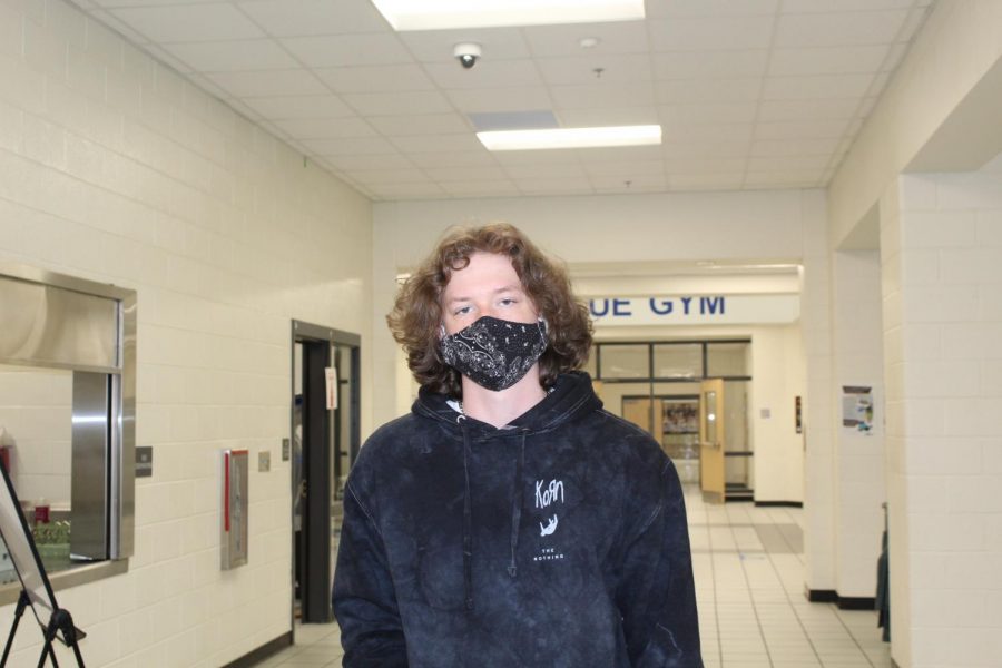 Unique patterns. Cody Strozensky, a student at South Forsyth High School, wears a black uniquely patterned mask with a dark hoodie. With the pandemic, students have been seen with some pretty unique and colorful masks.