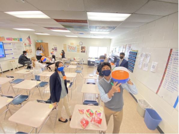 Building socially-distanced relationships.  This image was captured at the FBLA Fuel 2020, the virtual Fall Leadership Conference.  Teachers allowed few students into classrooms to participate workshops and practice testing rooms. In the pictured room, students participated in an ice-breaker activity that involved writing FBLA goals on beach balls, and passing them across the room. Additionally, students participated in workshops regarding business communication and officer-ship in FBLA.