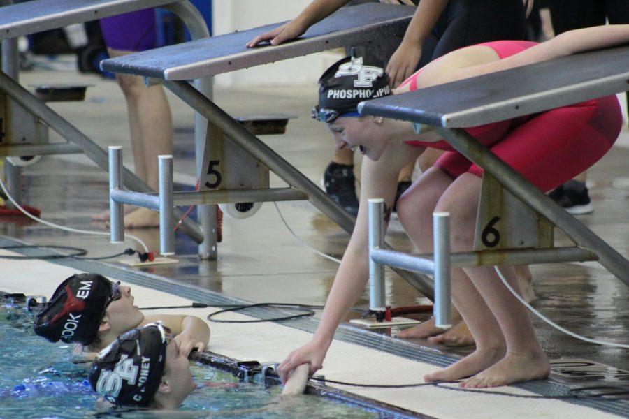 Taking home the gold. Senior Grace Drawdy and Sophomore Charlotte Tully share a moment after they beat their rival, Lambert High School, in the 4x100 yard freestyle relay. The win came unexpectedly, as the Lady War Eagles placed 3rd overall in the previous relays earlier in the morning. 