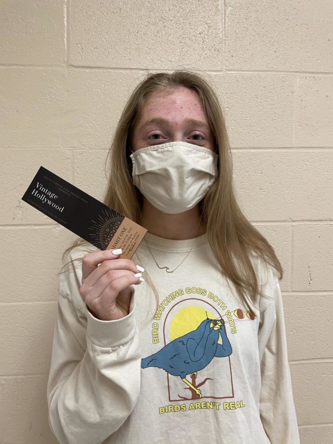 Senior Megan Milstead holding her prom ticket. Milstead is glad to finally have her ticket after waiting in the long line for prom tickets. Milstead was sure to be at ticket sales right at 2:00. She waited in line for 30 minutes to receive her own ticket and a guests ticket. 