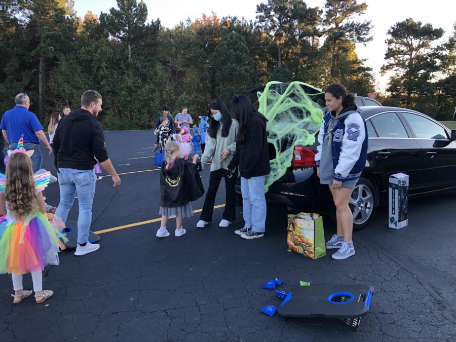 Spooky season. SFHS Beta Club officers cover their trunk in cobwebs to get into the Halloween spirit. The children also played a competitive game of cornhole with the officers for some extra fun. 
