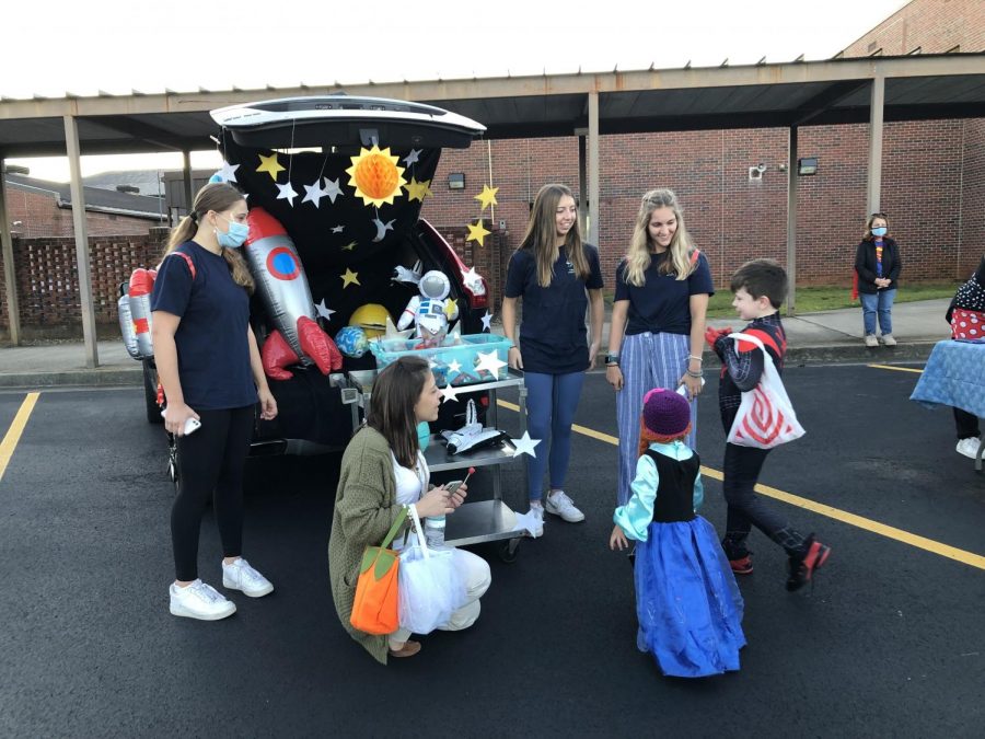 To infinity and beyond. SFHS FCCLA (Family, Career and Community Leaders of America) officers fill their car with stars and rockets as they soar into space. The enthusiastic children grabbed handfuls of lollipops at this trunk.