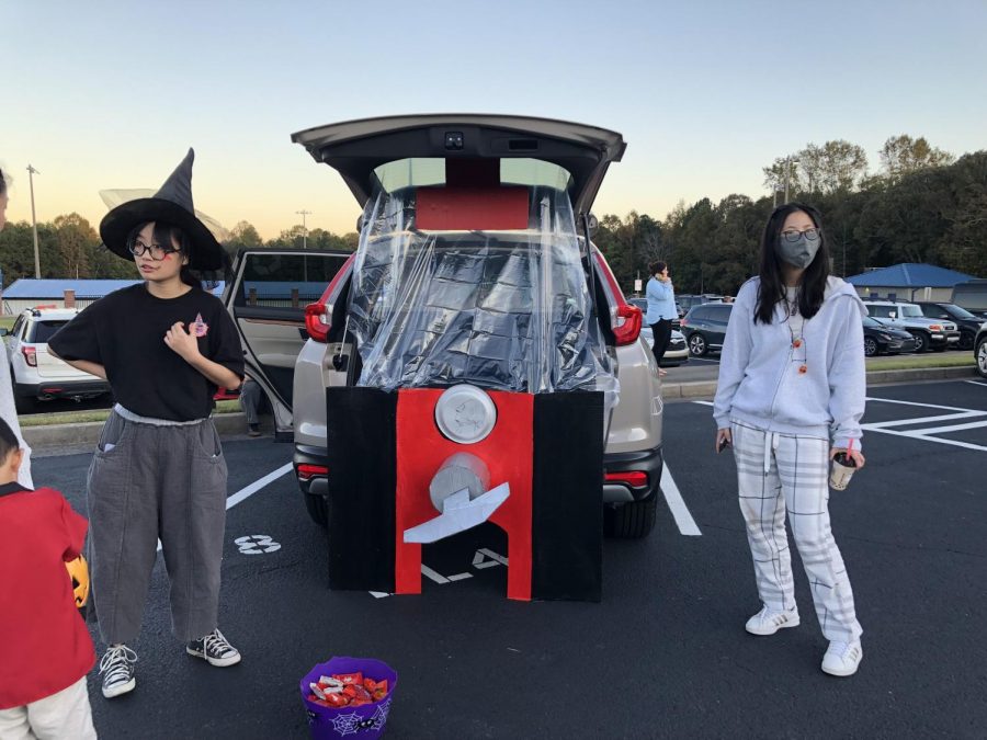 An artistic Halloween. SFHS National Art Honor Society decorates their car to match the design of a candy dispenser.
The life-size dispenser fascinated the young children as it gave them the candy.