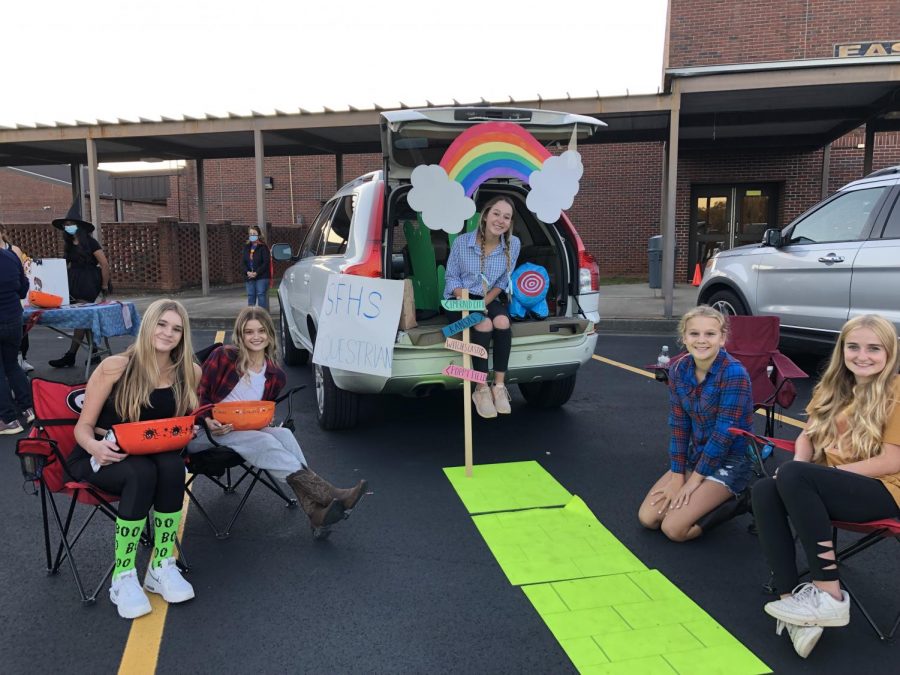 The yellow brick road. The SFHS Equestrian team adorns their car with deocorations to match the movie The Wizard of Oz. The children were esctatic to see the members dressed up in costume as they walked down the famous yellow brick road to get their candy.