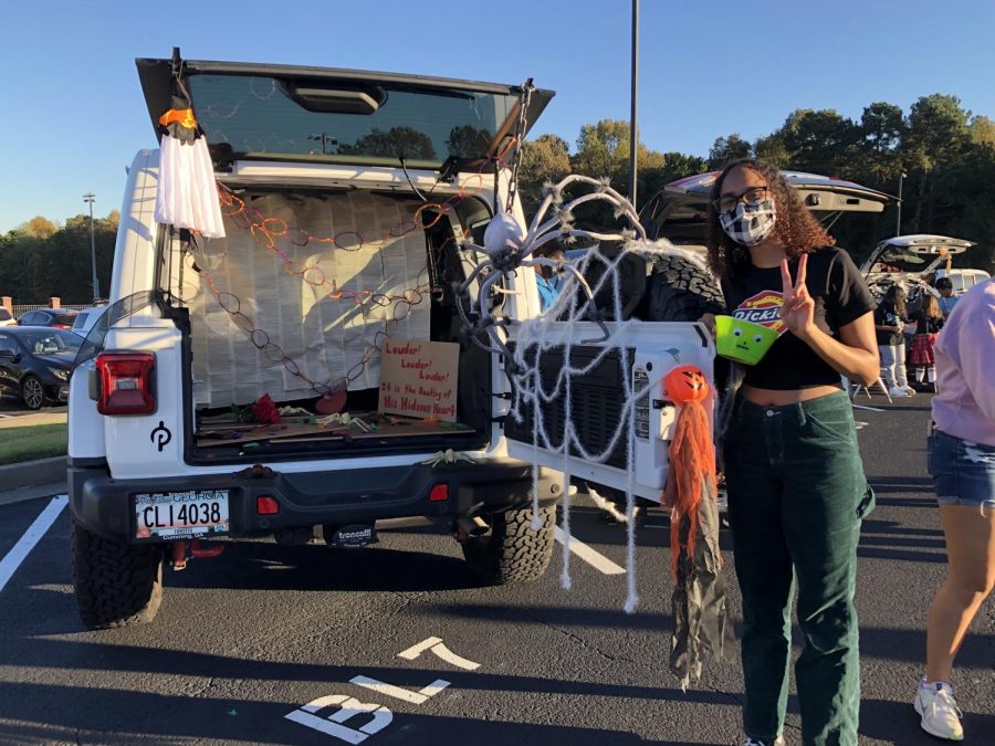 A trunk full of spiders. SFHS National English Honor Society members decorate their trunk with creative ghosts and webs to fit the theme of The Tell-Tale Heart. The trick-or-treaters enjoyed playing a game to get a bean bag into the plastic pumpkins. 