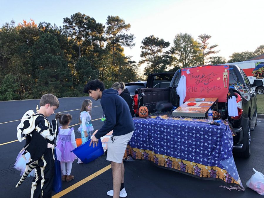 Debating for the treats. SFHS Debate Team set up a cornhole station for kids to come and enjoy throughut the night. Children loved filling their bucket with extra candy as they threw the beanbag into the hole.
