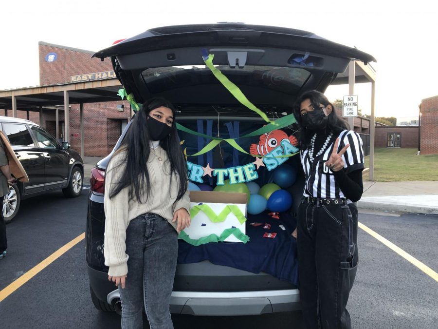 Swimming for sweets. Volunteers from SFHS Science National Honor Society fill their trunk with under the sea decorations as they wait to hand out candy to the trick-or-treaters. The children enjoyed seeing and playing games with the inflatable Nemo.