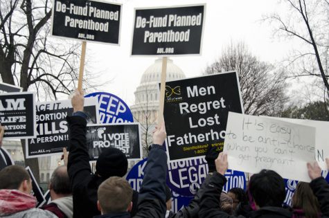On January 23, 2012, the anniversary of Roe Vs. Wade, anti-abortion activists and the National Organization of Women protested outside the Supreme Court. The pro-life supporters held up signs against Planned Parenthood, advocating for the Supreme Court to de-fund the organization.