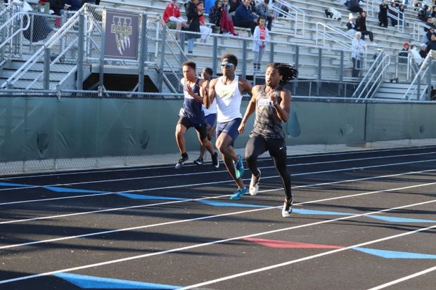 Boys 100 meter dash. Junior Chris Nelson races to the finish ahead of West, Lambert, Denmark, and Central sprinters. 