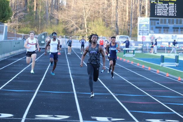 Forsyth County. In the 4x100 meter relay A team, Junior Chris Nelson speeds through the finish line. He positioned as anchor and held his first place spot all the way to the end.