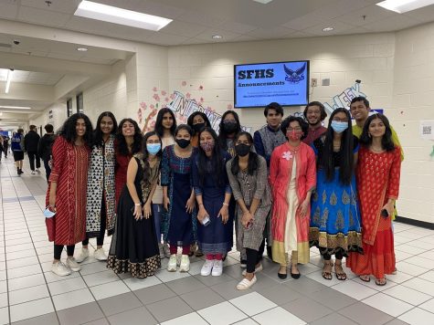 Bindis and bangles. Seniors crowd together as they take a picture in their beautiful Indian cultural outfit. The seniors above gained the attention of many as they walked the halls in their memorable and elegant outfits.