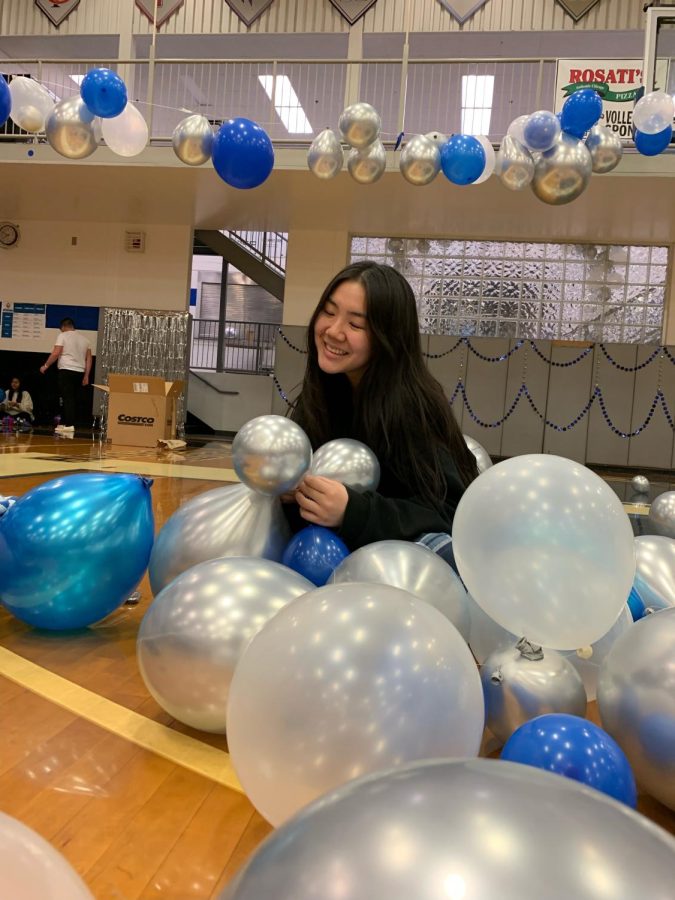 Angela Tan, a senior at South, setting up decorations for the Homecoming Dance at SFHSs Blue Gym in Cumming, GA. on Friday, Oct. 21, 2022. South Forsyths student council arrived at the gym before the dance and arranged the various decorations. 