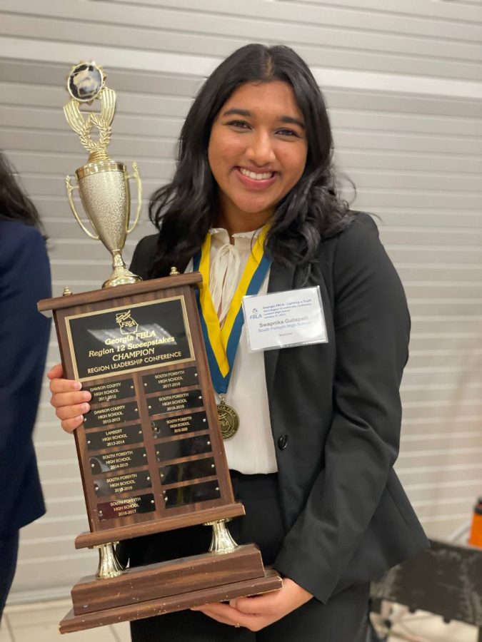 South+senior+Swapnika+Gullapalli+shows+off+South+FBLAs+accomplishments+at+the+Region+Leadership+Conference.+Gullapalli+has+been+involved+in+FBLA+for+all+four+years+of+high+school.
