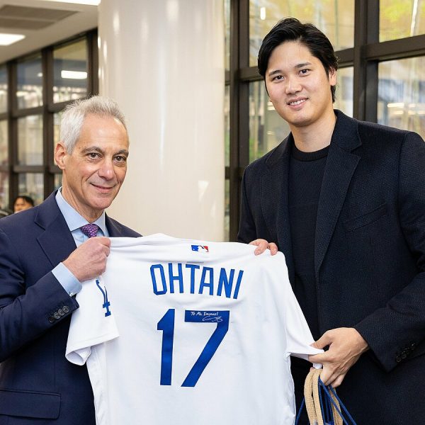  Shohei Ohtani holds up his new Dodgers jersey with Rahm Emanuel, the US Ambassador to Japan. Ohtani recently signed with the Dodgers.
