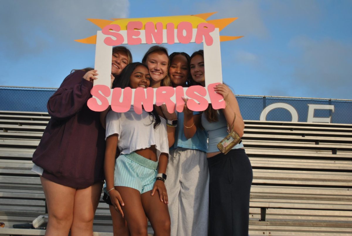 Seniors Mackenzie Lochhead, Marissa Mistry, Grace Viviano, Karen Wright and Taylor Henley pose with STUCO Senior Sunrise cut-out