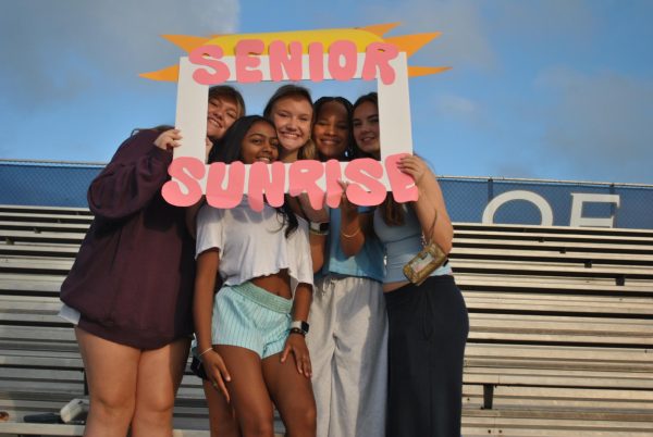 Seniors Mackenzie Lochhead, Marissa Mistry, Grace Viviano, Karen Wright and Taylor Henley pose with STUCO Senior Sunrise cut-out