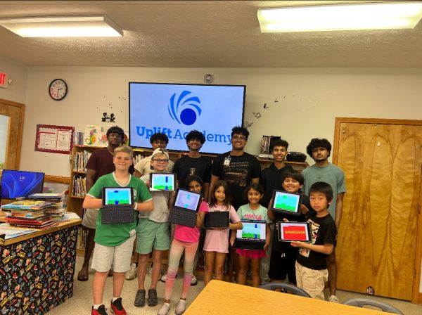 The Uplift Academy team and volunteers pose with Forsyth County School students after a lesson