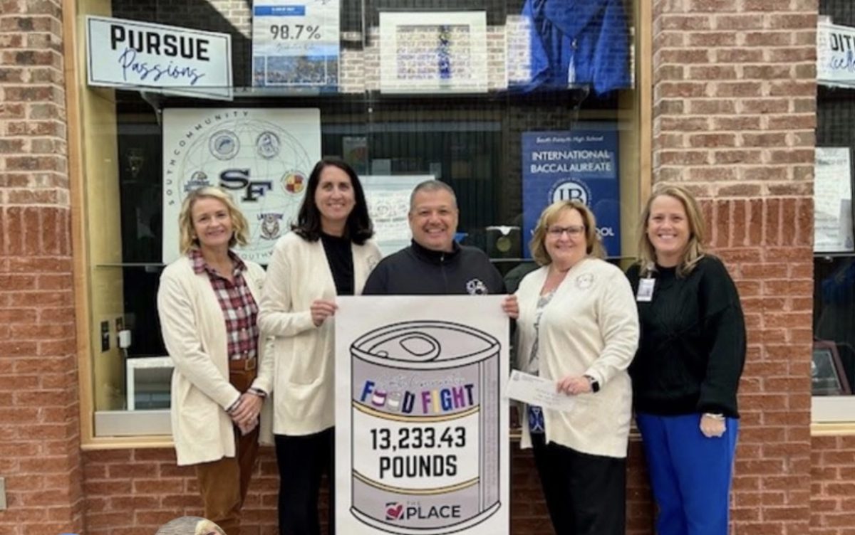 South Community Principals pose with the 'Fight Against' Hunger' campaign poster after raising 13,233.43 pounds of food