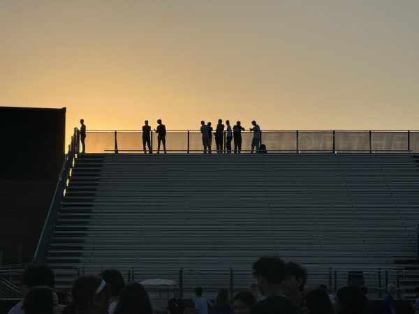 Seniors watching the sunset for the last time on the War Eagle Stadium